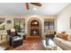 Charming living room with fireplace and views to the outside, plus cozy seating at 1261 Burning Tree Ln, Winter Park, FL 32792