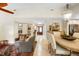 Inviting living room with comfortable seating and stylish decor, leading to a dining area and the home's entrance at 1261 Burning Tree Ln, Winter Park, FL 32792