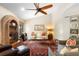 Bright living room featuring a brick fireplace, plush seating, and ample natural light at 1261 Burning Tree Ln, Winter Park, FL 32792