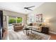 Comfortable living room features stylish seating, ceiling fan, a large area rug and sliding glass door to the pool at 1261 Burning Tree Ln, Winter Park, FL 32792