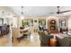 Open-concept living space with dining area, fireplace, and inviting seating, creating a warm ambiance at 1261 Burning Tree Ln, Winter Park, FL 32792