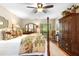 Bright main bedroom features a four-poster bed, ceiling fan, an area rug and multiple windows at 1261 Burning Tree Ln, Winter Park, FL 32792