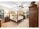 Comfortable main bedroom features a four-poster bed, ceiling fan, an area rug and multiple windows at 1261 Burning Tree Ln, Winter Park, FL 32792