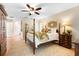 Bright main bedroom features a four-poster bed, ceiling fan, an area rug and multiple windows with en-suite bathroom at 1261 Burning Tree Ln, Winter Park, FL 32792