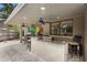 Outdoor kitchen featuring a granite countertop, seating, and a ceiling fan at 1261 Burning Tree Ln, Winter Park, FL 32792
