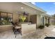 Covered outdoor kitchen area with bar seating, granite counters, and ceiling fan at 1261 Burning Tree Ln, Winter Park, FL 32792