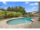 A refreshing in-ground pool surrounded by a brick patio and lush landscaping in the backyard at 1261 Burning Tree Ln, Winter Park, FL 32792