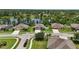 An aerial view of a neighborhood with beautiful homes situated on a lake with mature tree coverage at 1314 Lake Baton Dr, Deltona, FL 32725