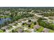 An aerial view of a neighborhood showcasing lush landscaping and a tranquil lake setting at 1314 Lake Baton Dr, Deltona, FL 32725