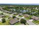 Aerial view of a community with a picturesque lake and well-maintained lawns and landscaping at 1314 Lake Baton Dr, Deltona, FL 32725