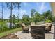 Inviting back patio seating area offering a serene view of the lake and lush greenery at 1314 Lake Baton Dr, Deltona, FL 32725