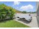 Grassy backyard features boat trailer parking pad and privacy fence at 1314 Lake Baton Dr, Deltona, FL 32725