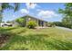 Landscaped backyard with lush greenery, mature trees, and ample space at 1314 Lake Baton Dr, Deltona, FL 32725