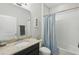 Bathroom with granite countertops, shower with curtain, and neutral walls at 1314 Lake Baton Dr, Deltona, FL 32725