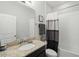 Bathroom featuring a single vanity with granite countertop, a toilet, and a shower-tub combo at 1314 Lake Baton Dr, Deltona, FL 32725