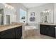 Bright bathroom featuring granite countertops, soaking tub and dual sinks at 1314 Lake Baton Dr, Deltona, FL 32725