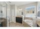 Bathroom featuring a soaking tub, glass-enclosed shower, and a vanity with granite countertops at 1314 Lake Baton Dr, Deltona, FL 32725