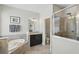 Modern bathroom featuring a soaking tub, glass shower, and elegant vanity at 1314 Lake Baton Dr, Deltona, FL 32725