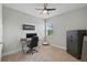 Bedroom with neutral walls has an office desk, a ceiling fan, and a Winchester safe at 1314 Lake Baton Dr, Deltona, FL 32725