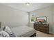 Neutral bedroom featuring a dresser, plush carpet, and window with a view at 1314 Lake Baton Dr, Deltona, FL 32725