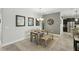 A dining room has stylish mirrors, a table, and a bench on top of a textured rug in neutral tones at 1314 Lake Baton Dr, Deltona, FL 32725