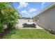 Long driveway offers ample parking and secure storage with grass and tropical landscaping at 1314 Lake Baton Dr, Deltona, FL 32725
