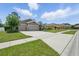 Charming single-story home features a three-car garage, well-manicured lawn, and neutral color palette at 1314 Lake Baton Dr, Deltona, FL 32725