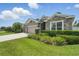 Attractive home boasts stone accents, a well-kept lawn, and a paved driveway leading to a spacious garage at 1314 Lake Baton Dr, Deltona, FL 32725
