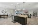 Kitchen island with seating, complemented by pendant lighting and open layout to the living area at 1314 Lake Baton Dr, Deltona, FL 32725