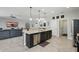 Modern kitchen island with bar stools opens to living area, perfect for entertaining at 1314 Lake Baton Dr, Deltona, FL 32725