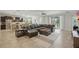 Open-concept living space with tile floors, a kitchen, dining area, and large sectional sofa at 1314 Lake Baton Dr, Deltona, FL 32725