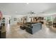 Spacious living area with tile floors, an open layout, modern lighting, and dark brown sofa at 1314 Lake Baton Dr, Deltona, FL 32725