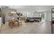 Open-concept living space with tile floors, a kitchen, dining area, and large sofa at 1314 Lake Baton Dr, Deltona, FL 32725