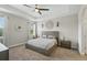 Serene main bedroom with neutral tones, tray ceiling, and stylish decor at 1314 Lake Baton Dr, Deltona, FL 32725