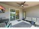 Relaxing screened patio with fan, outdoor seating and a view of the lake at 1314 Lake Baton Dr, Deltona, FL 32725
