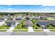 Aerial view of the neighborhood with many houses and trees on a sunny day at 1323 Donatello Ln, Winter Haven, FL 33884