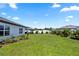 View of the backyard with a garden on a sunny day at 1323 Donatello Ln, Winter Haven, FL 33884