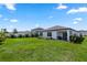 View of the backyard with a grill and a lawn at 1323 Donatello Ln, Winter Haven, FL 33884