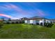 View of the backyard with a grill and a lawn at 1323 Donatello Ln, Winter Haven, FL 33884
