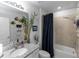 Bathroom with plants and a mirror with fish decorations, vanity and shower with a dark curtain at 1323 Donatello Ln, Winter Haven, FL 33884