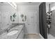 Bathroom features double sinks, granite countertops, large mirror, shower and fish-themed decor at 1323 Donatello Ln, Winter Haven, FL 33884