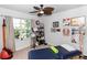 Bright bedroom with a ceiling fan, a window and a medical examination bed at 1323 Donatello Ln, Winter Haven, FL 33884