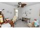 Home office with a ceiling fan, wooden desk with a white chair and a window view at 1323 Donatello Ln, Winter Haven, FL 33884