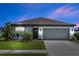 Charming single-story home featuring a well-manicured lawn and a two-car garage, perfect for comfortable living at 1323 Donatello Ln, Winter Haven, FL 33884