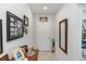 Welcoming front foyer with neutral walls, tile flooring, a decorative mirror, and tasteful decor at 1323 Donatello Ln, Winter Haven, FL 33884