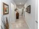 View of the Hallway with decorations, paintings and a lighting lamp on a cabinet at 1323 Donatello Ln, Winter Haven, FL 33884