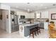 Bright and airy kitchen with a large island, stainless steel appliances, and modern white cabinetry at 1323 Donatello Ln, Winter Haven, FL 33884