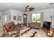 Comfortable living room featuring plush seating, a ceiling fan, and a large window for natural light at 1323 Donatello Ln, Winter Haven, FL 33884