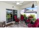View of the back porch with chairs and a ceiling fan at 1323 Donatello Ln, Winter Haven, FL 33884