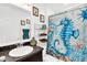 Nautical-themed bathroom with sea-inspired decor, patterned shower curtain, and dark countertops at 136 Columbia Dr, Kissimmee, FL 34759